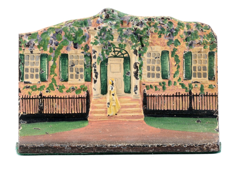 CAST IRON COTTAGE WITH WOMAN ON STEPS DOORSTOP.