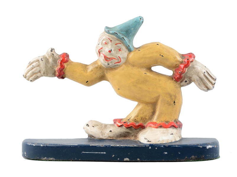 CAST IRON CLOWN WITH ARM STRETCHED OUT DOORSTOP.