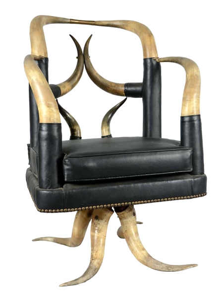 HORNED ARMCHAIR WITH BLACK UPHOLSTERY.