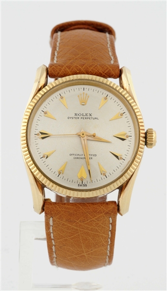 ROLEX OYSTER PERPETUAL 14K YELLOW GOLD FLUTED BEZEL WITH BOMBAY LUGS SHARK TOOTH MARKERS.