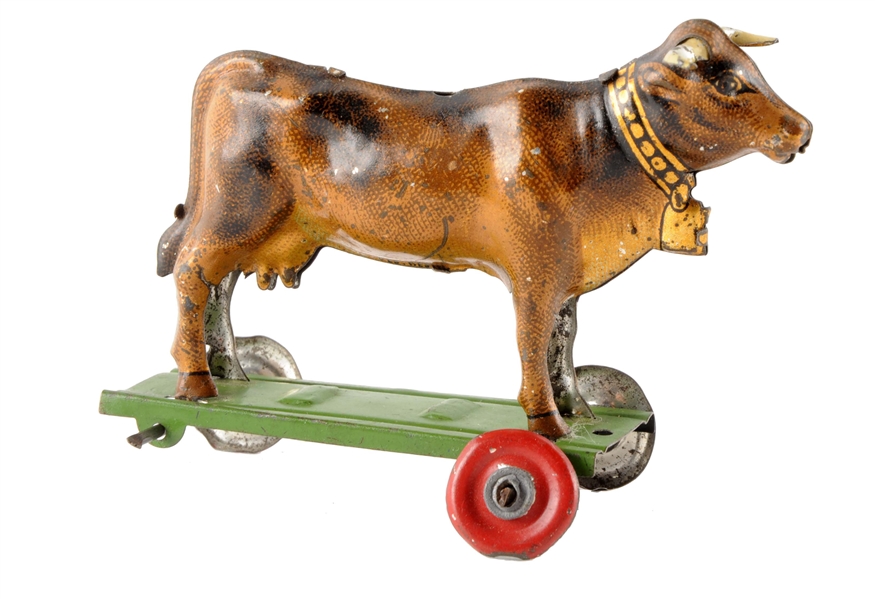 GERMAN TIN LITHO COW ON PLATFORM PENNY TOY.