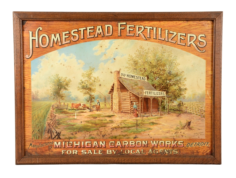 TIN "HOMESTEAD FERTILIZERS" SIGN WITH WOOD FRAME.