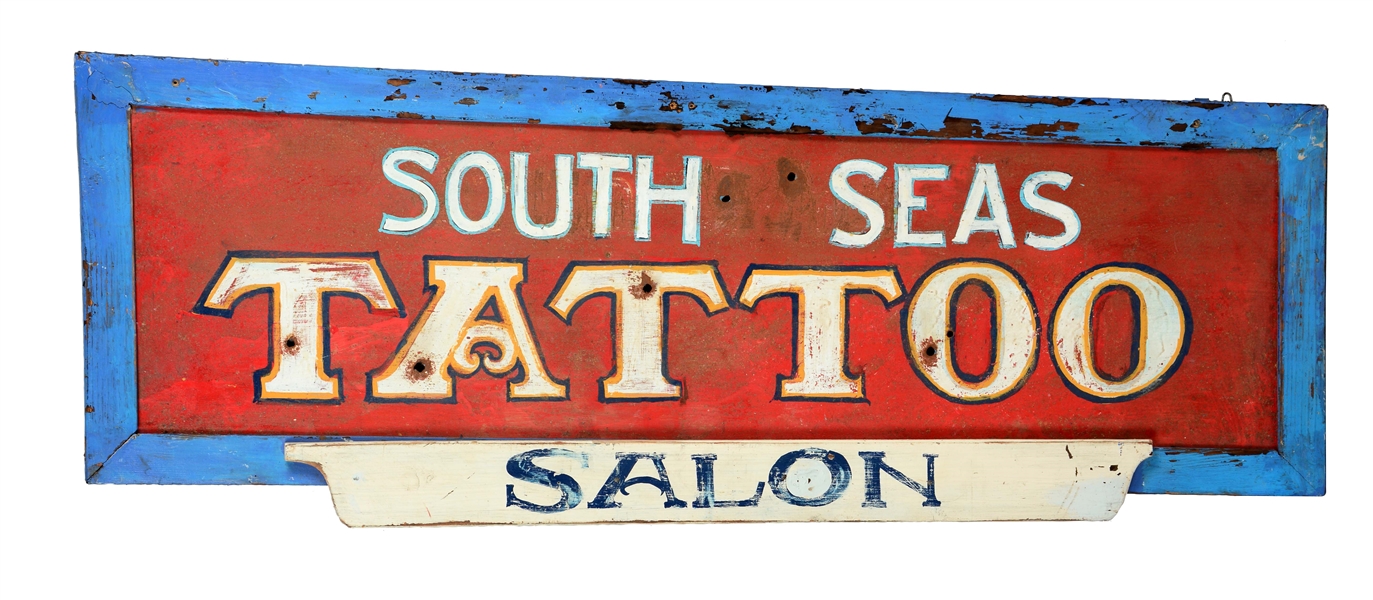 TIN "SOUTH SEAS TATTOO SALON" WITH A WOODEN FRAME. 