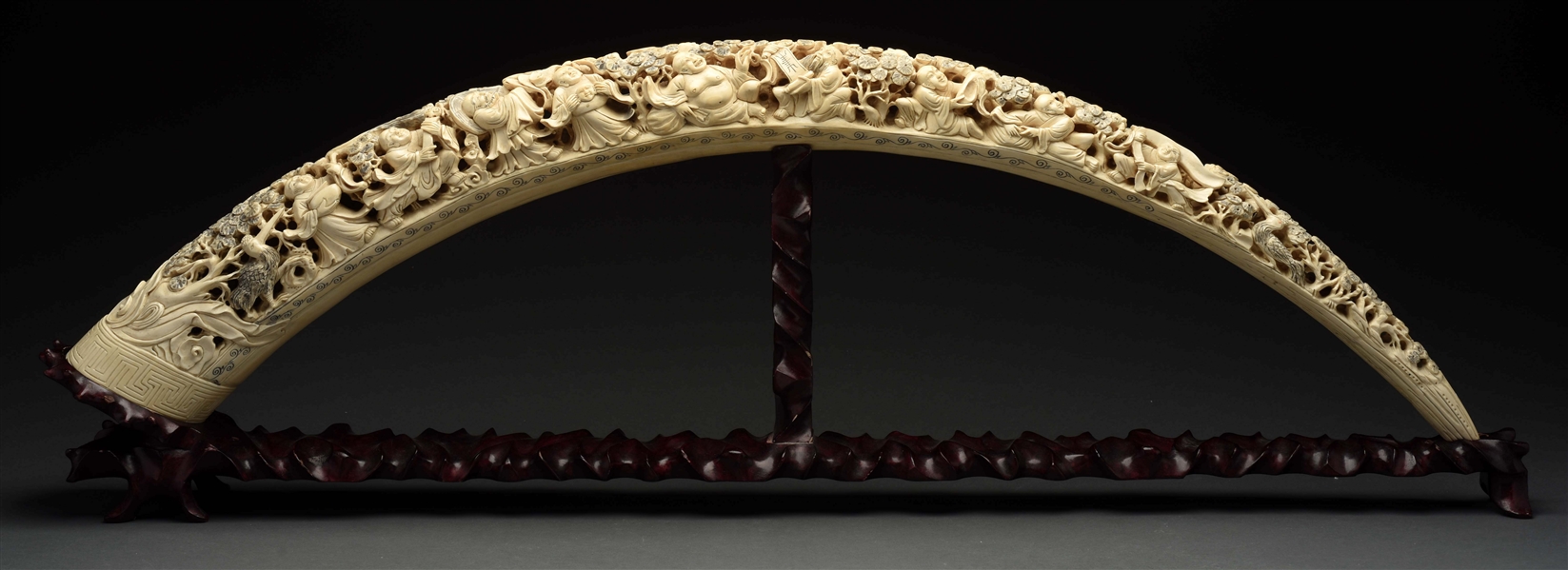 CARVED ELEPHANT IVORY TUSK WITH STAND. 