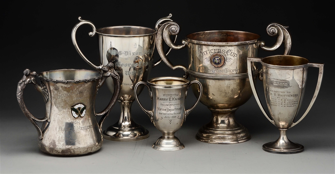 FIVE STERLING TROPHY CUPS.