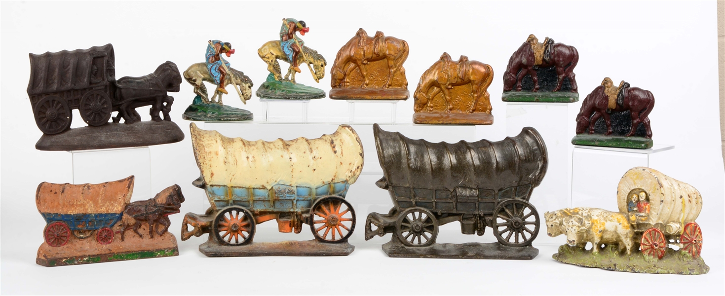 LOT OF 8: CAST IRON COVERED WAGON DOORSTOPS & BOOKENDS.