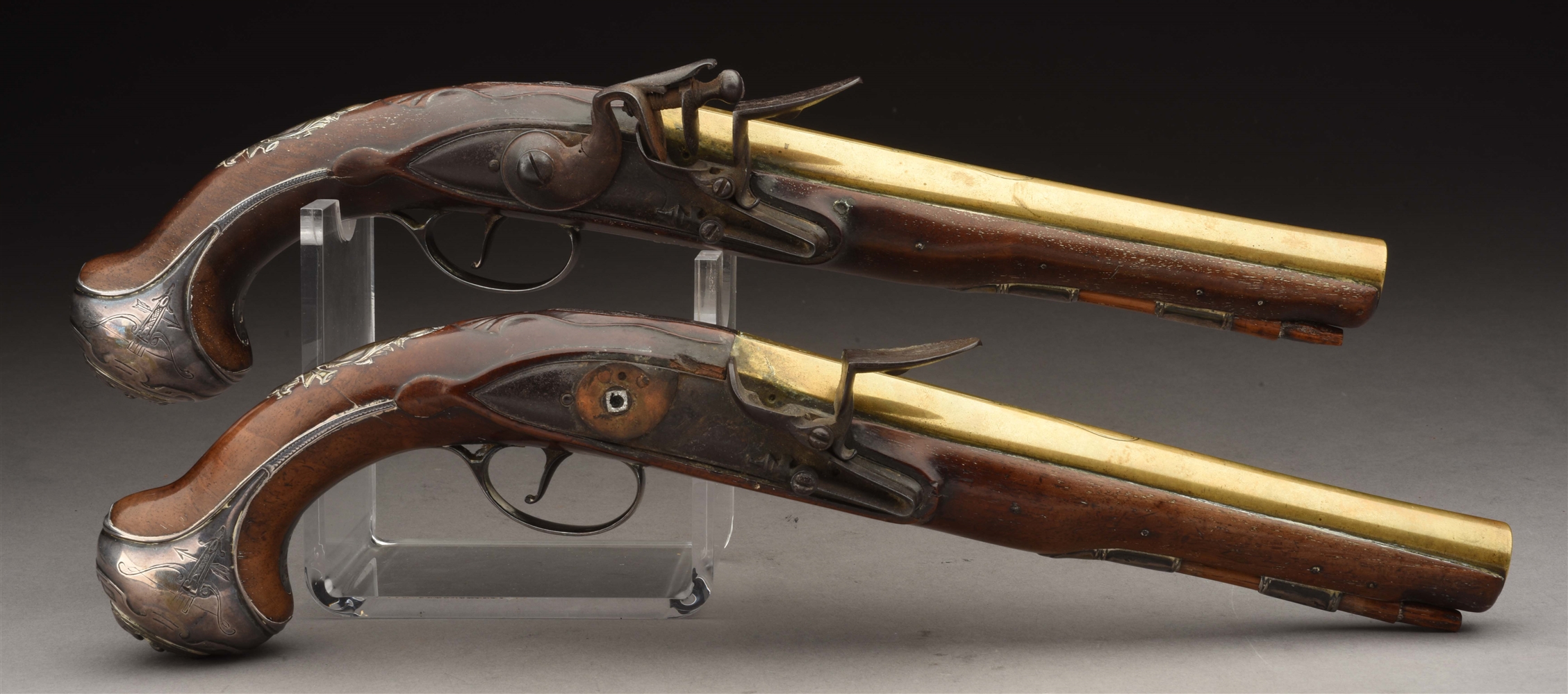 (A) PAIR OF BRASS BARRELED AND SILVER MOUNTED FLINTLOCK OFFICERS PISTOLS BY WILSON.