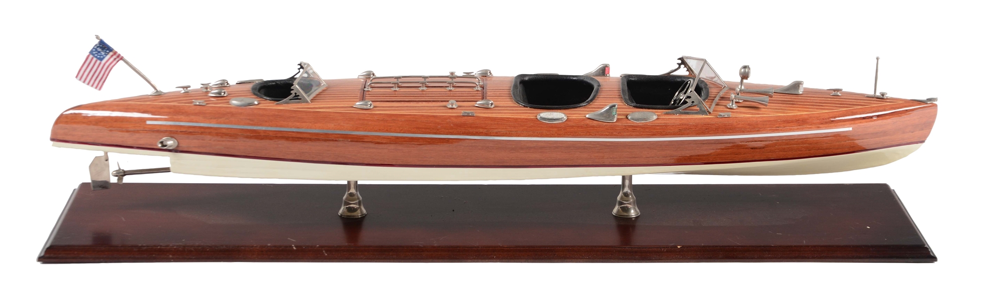 CONTEMPORARY WOODEN MODEL SPEED BOAT WITH AMERICAN FLAG ON STAND.