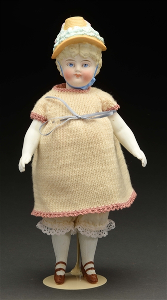 UNUSUAL ALL BISQUE CHILD WITH MOLDED HAT.