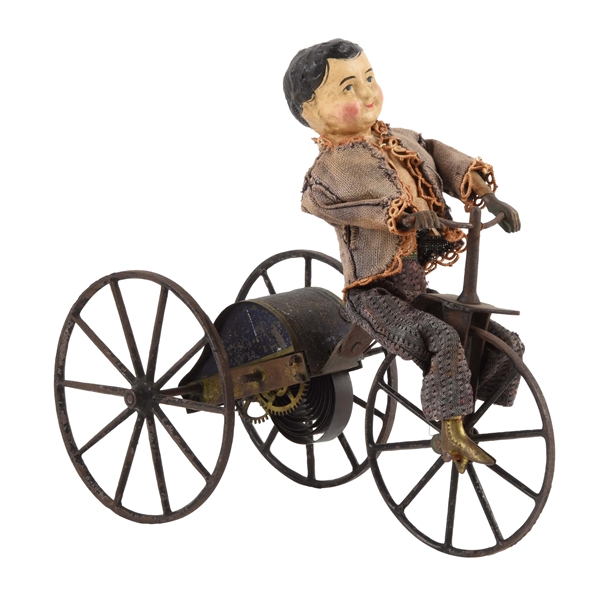 EARLY GEORGE BROWN CLOCKWORK BOY ON VELOCIPEDE TOY.