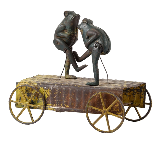 EARLY CAST IRON FROGS ON TIN BASE BELL TOY.