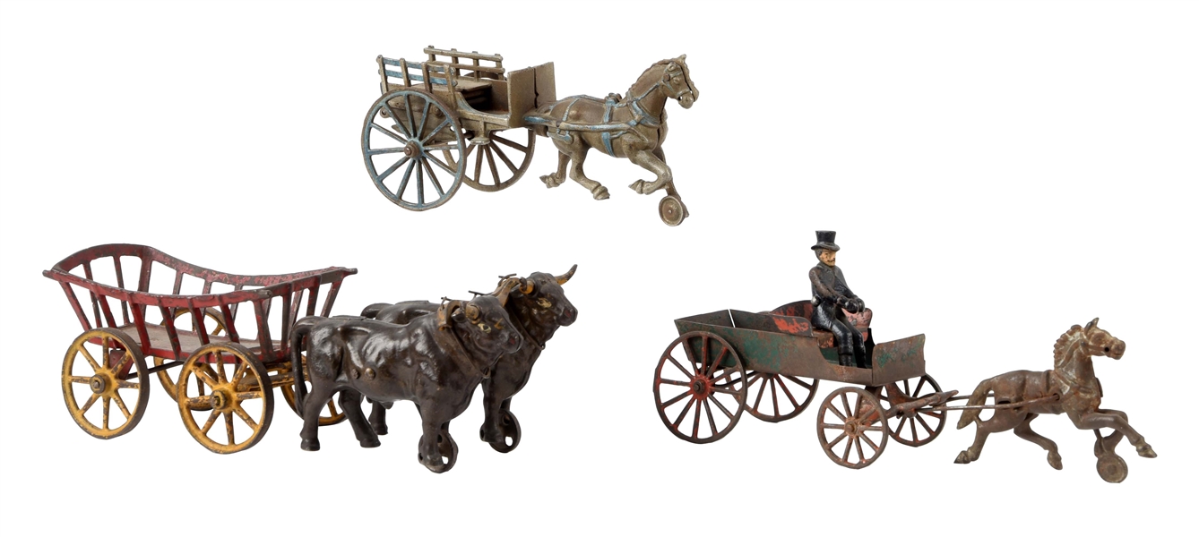 LOT OF 3: CAST IRON AMERICAN-MADE ANIMAL DRAWN WAGONS.