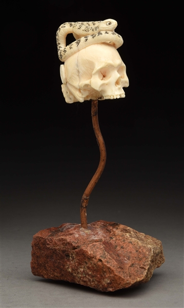 JAPANESE IVORY CARVING OF SKULL WITH SNAKE.