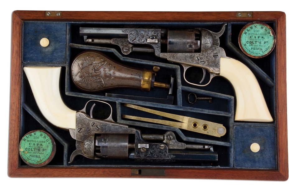 (A) SUPERB CASED PAIR OF CONSECUTIVELY NUMBERED FACTORY ENGRAVED COLT MODEL 1849 POCKET REVOLVERS WITH IVORY GRIPS (1853).