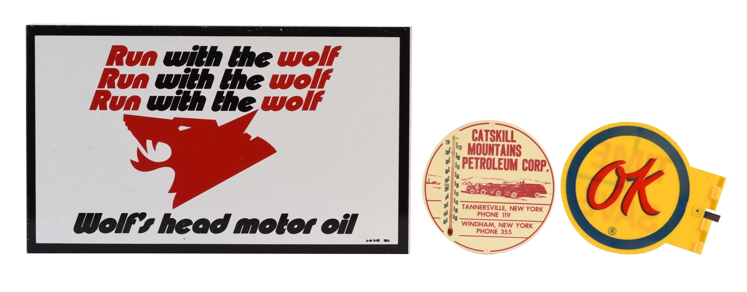LOT OF 3: WOLFS HEAD MOTOR OIL TIN FLANGE SIGN WITH CATSKILL PEROLEUM THERMOMETER & OK USED CARS PLASTIC SIGN.