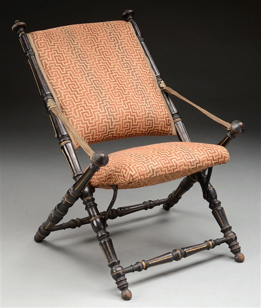 EBONIZED, INCISED AND GILDED FOLDING CHAIR IN THE AESTHETIC TASTE                                                                                                                                       