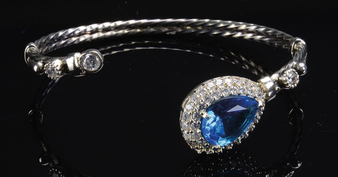 DESIGNER STERLING BANGLE BRACELET WITH SIMULATED DIAMONDS AND BLUE STONES.                                                                                                                              