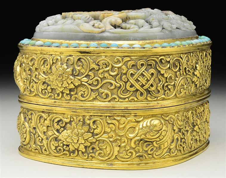 GILT BRONZE BUDDHIST BOX AND COVER WITH LARGE JADE INLAY.                                                                                                                                               