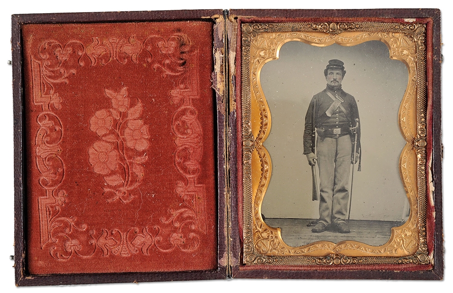 EXTREMELY FINE QUARTER PLATE TINTYPE OF UNION CAVALRYMAN WITH CARBINE AND SWORD.                                                                                                                        