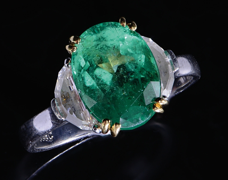 PLATINUM OVAL EMERALD & HALF MOON DIAMOND RING.                                                                                                                                                         