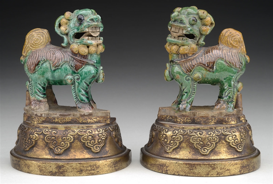 PAIR OF POTTERY FOO DOG STATUES MOUNTED AS BOOKENDS.                                                                                                                                                    