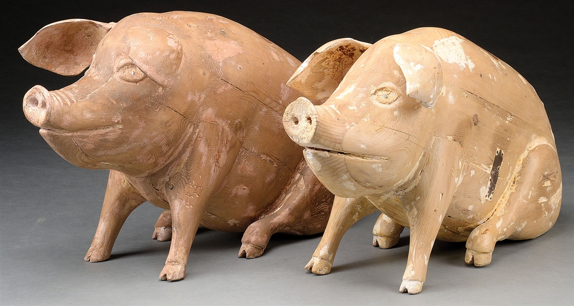 RARE AND UNUSUAL PAIR OF CARVED PINE SEATED PIG TRADE SIGNS.                                                                                                                                            
