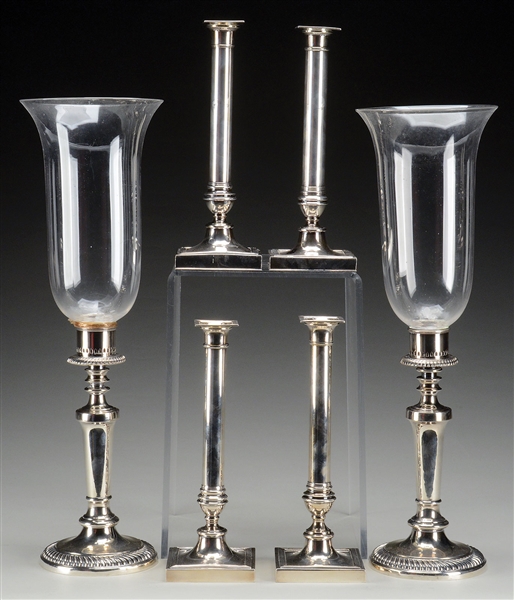 TWO PAIR OF SIMILAR SILVER PLATED CANDLESTICKS AND A PAIR OF SHEFFIELD HURRICANE LAMPS.                                                                                                                 