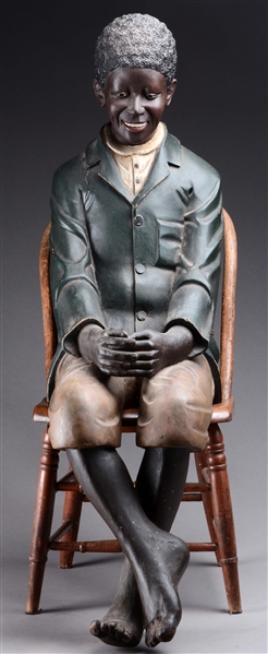 EXCEPTIONAL BLACK FOLK ART CARVING OF A YOUNG BOY.