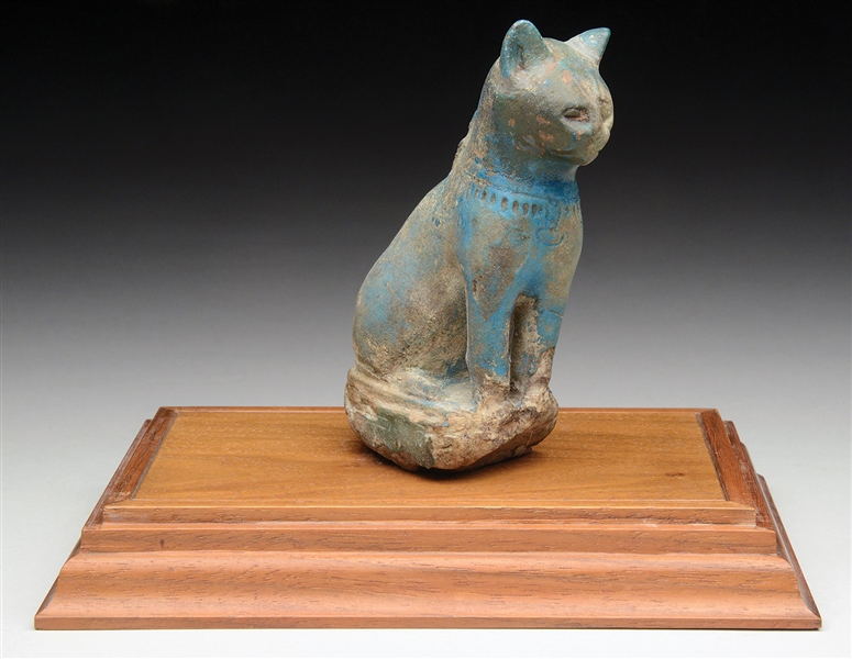 EGYPTIAN FAIENCE FIGURE IN THE FORM OF A CAT.                                                                                                                                                           