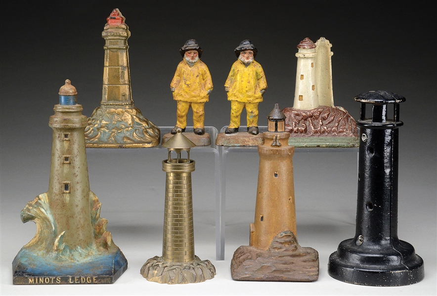 GROUP OF NINE CAST-IRON NAUTICAL DOOR STOPS TOGETHER WITH A LIGHTHOUSE STILL BANK.                                                                                                                      