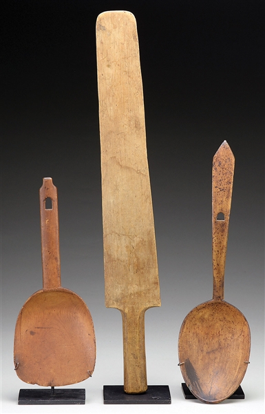 TWO NATIVE AMERICAN CARVED WOODEN SPOONS TOGETHER WITH CARVED WOODEN PADDLE.                                                                                                                            
