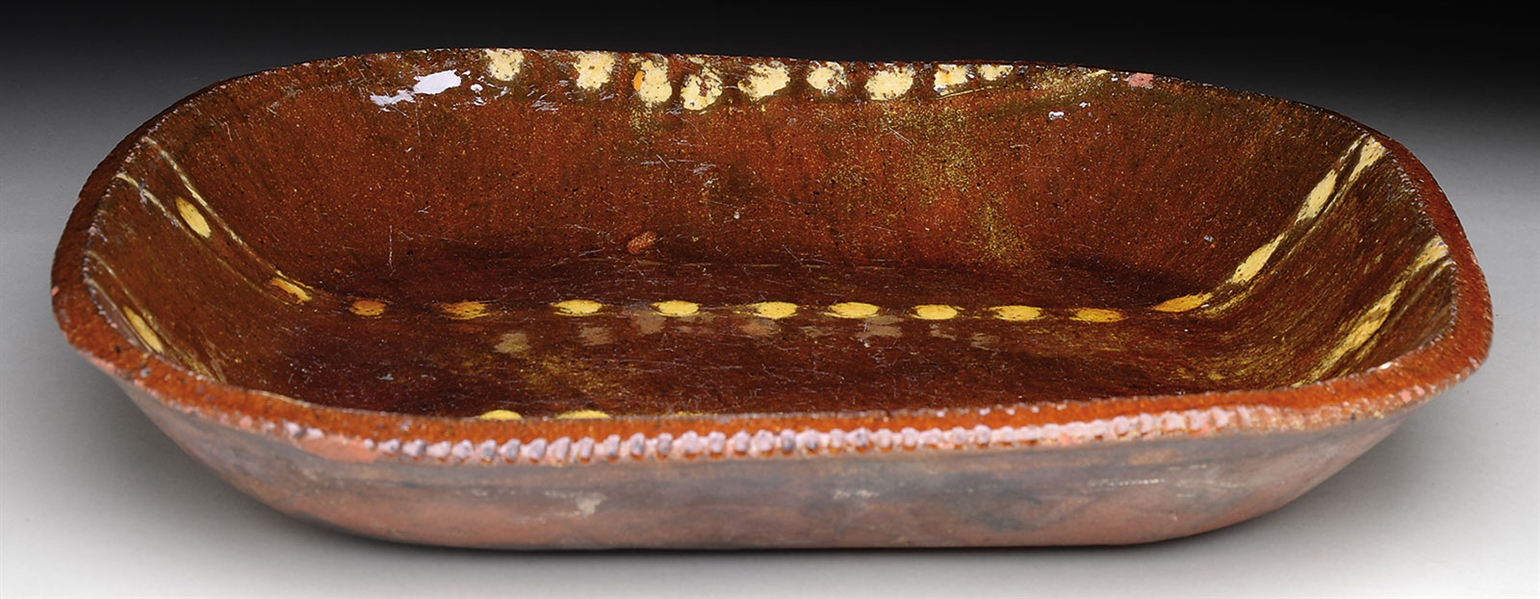 DECORATED REDWARE LOAF DISH.                                                                                                                                                                            