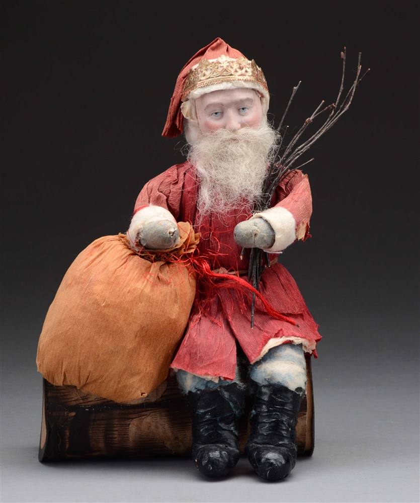 PAPER SANTA SITTING ON LOG CANDY CONTAINER.