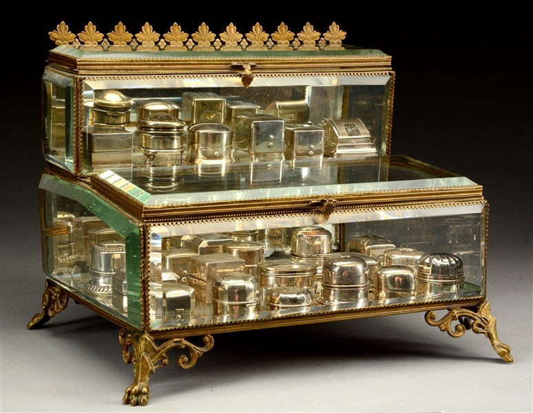 UNUSUAL BEVELED GLASS AND GILT METAL MOUNTED STEP BACK TABLETOP DISPLAY CASE.
