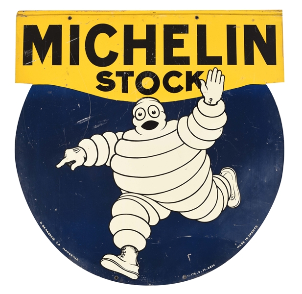 MICHELIN STOCK TIRES DIE-CUT TIN SIGN WITH BIBENDUM GRAPHIC.