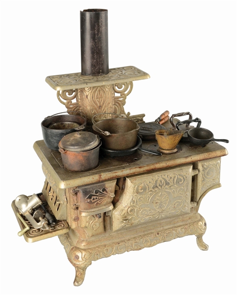 MINIATURE CAST IRON TOY STOVE WITH ACCESSORIES.