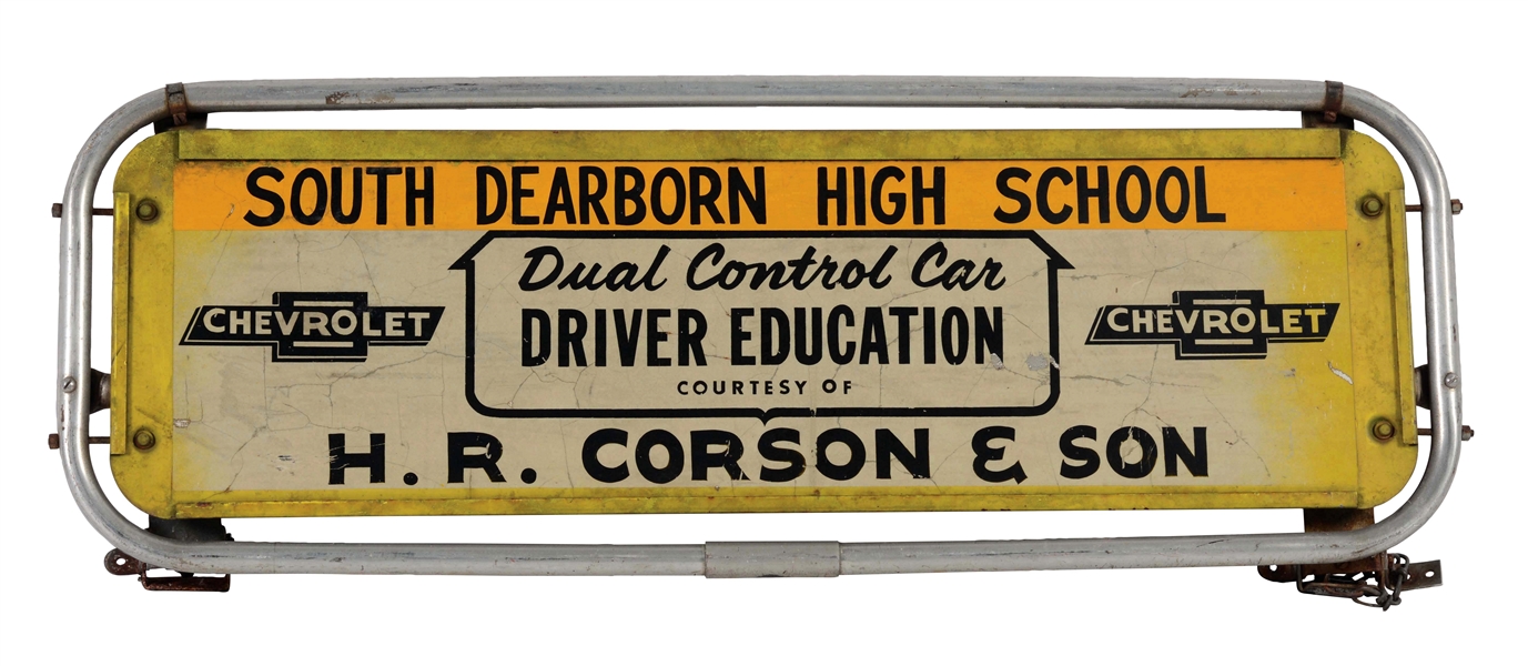 CHEVROLET DRIVERS EDUCATION TIN SIGN WITH METAL MOUNTING BRACKET.