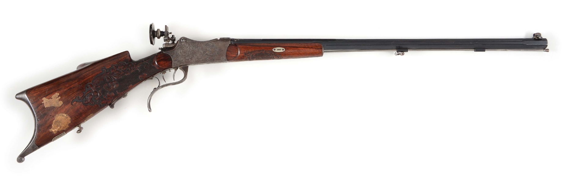 (C) A FINE AYDT SYSTEM GERMAN SCHUTZEN RIFLE WITH DEEPLY ENGRAVED ACTION, SILVER DECORATION ON BARREL, AND BEAUTIFULLY CARVED SCHUETZEN STOCK.