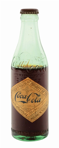 EARLY COCA-COLA BOTTLE WITH PAPER DIAMOND LABEL.