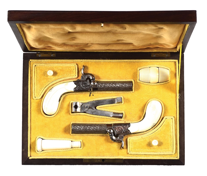 (A) AN ELEGANT CASED SET OF IVORY STOCKED BELGIAN PERCUSSION POCKET PISTOLS.