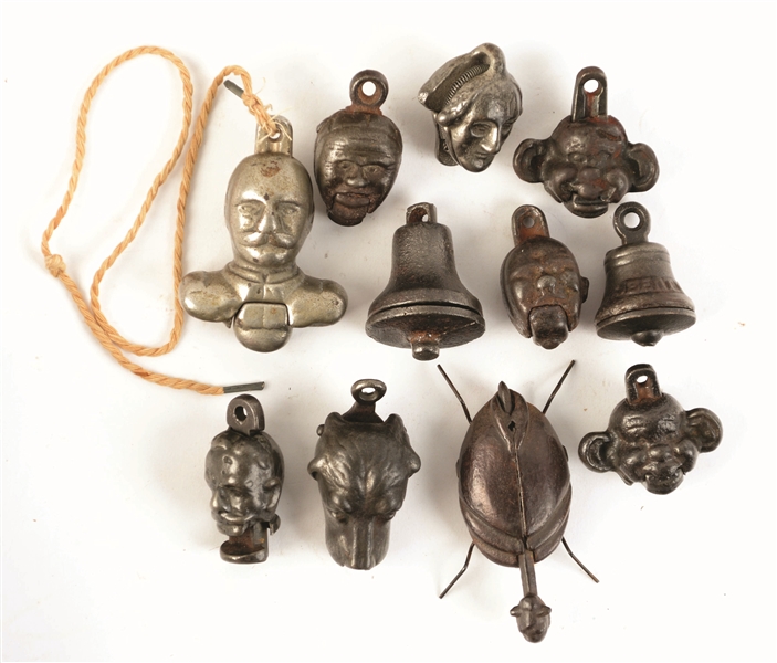 LOT OF 11: EARLY 20TH CENTURY CAST-IRON FIGURAL CAP BOMBS.