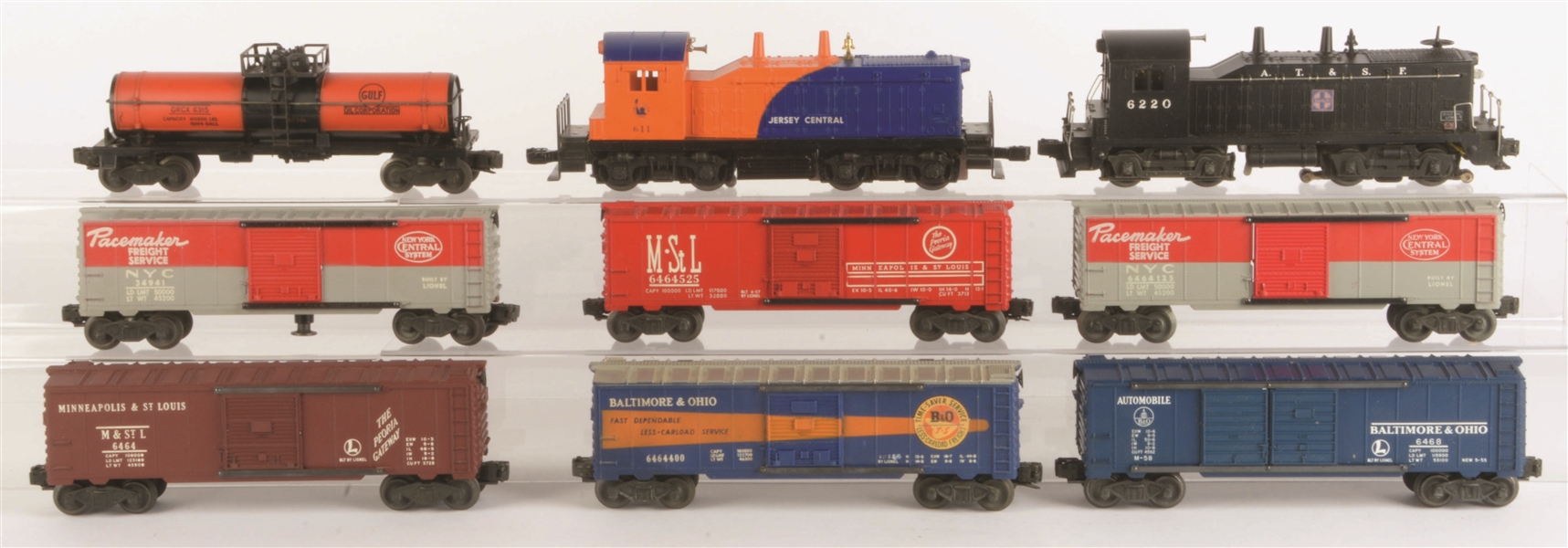 LOT OF 9: TWO LIONEL POST-WAR DIESELS & SEVEN ASSORTED FREIGHT CARS.