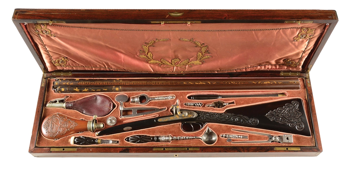(A) TRULY SUPERB QUALITY, BEAUTIFULLY RELIEF GOLD INLAID AND ENGRAVED PERCUSSION SHOTGUN BY KOEZI & JAHCHIMEK OF WARSAW AND KRAKOW IN ITS ORIGINAL HIGHLY EMBELLISHED ROSEWOOD CASE WITH ACCESSORIES.