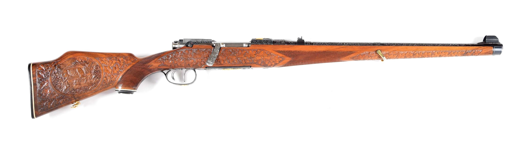 (C) OVER-THE-TOP MANNLICHER SCHOENAUER MODEL 1961 MCA CARBINE WITH NEARLY EVERY POSSIBLE FACTORY CUSTOM EMBELLISHMENT INCLUDING STOCK CARVINGS AND GOLD INLAY.