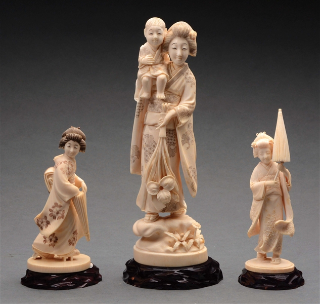 THREE NICELY CARVED IVORY FIGURES OF WELL-DRESSED WOMEN.