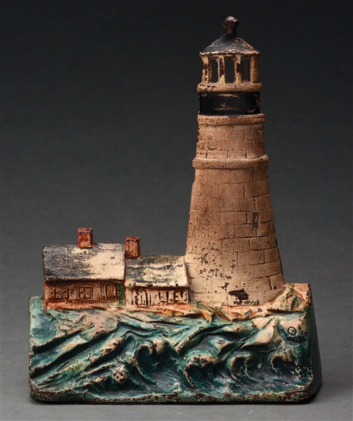 ANTIQUE CAST-IRON LIGHTHOUSE DOORSTOP WITH TWO COTTAGES.