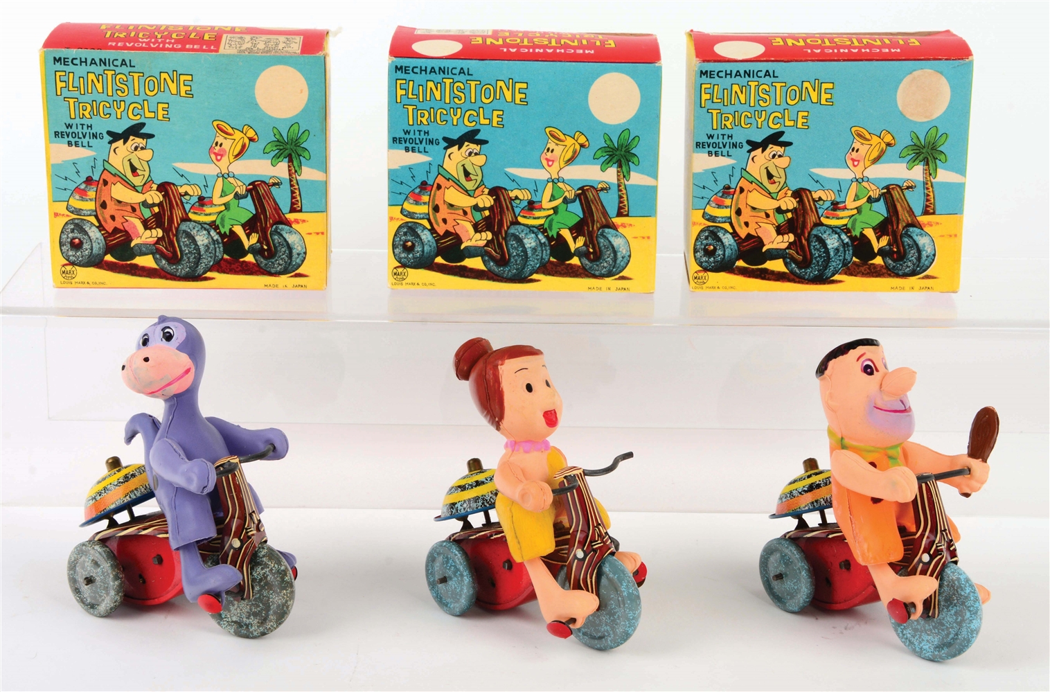 LOT OF 3: MARX TIN-LITHO AND CELLULOID FLINTSTONE TRICYCLE TOYS.
