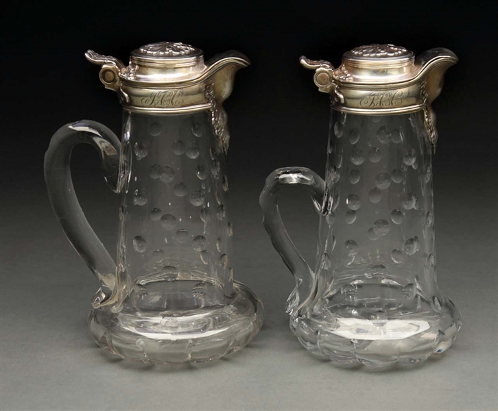 A PAIR OF TIFFANY STERLING MOUNTED CLARET JUGS.