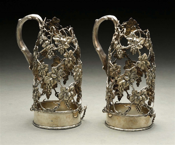 A MATCHED PAIR OF STERLING WINE BOTTLE HOLDERS.