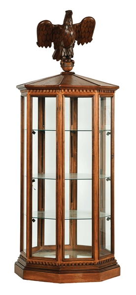 OCTAGONAL EAGLE TOPPED DISPLAY CASE.